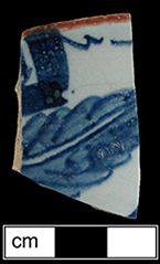 Punch bowl fragment painted in blue with a red rim.